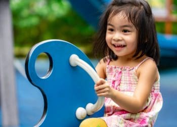 A young girl having fun in a playground.