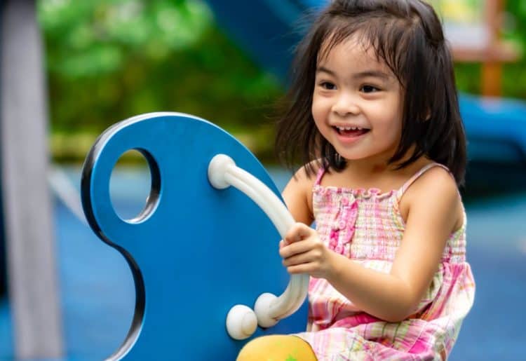 A young girl having fun in a playground.