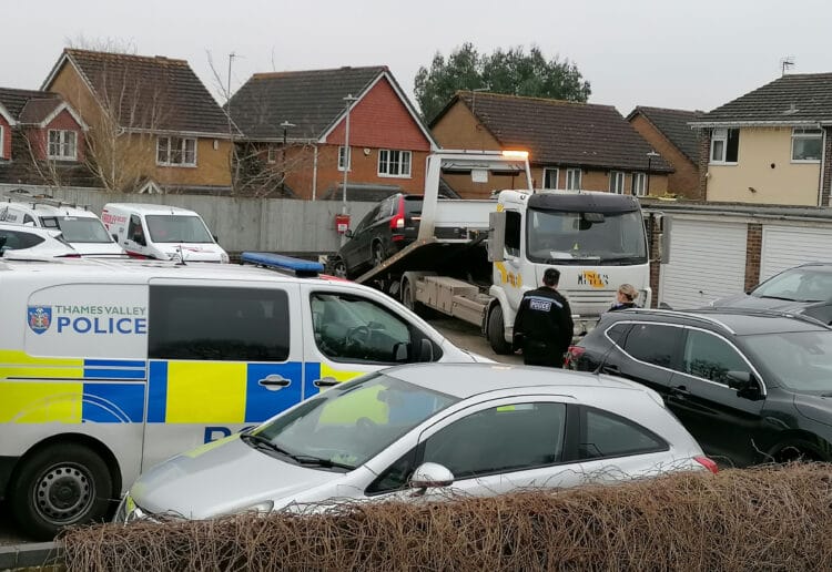 Police attending car removal in Lowfield Road, Caversham Park Village on Sunday. Picture: Steve Smyth