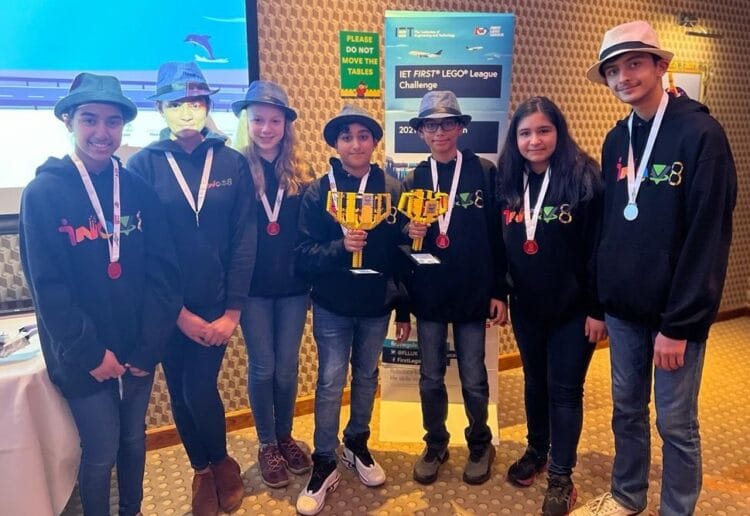 The members of team INOV8 Robotics show off their trophies after their First Lego League win