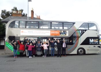 Members of Reading Buses and New Beginnings, including volunteers, in front of the branded bus