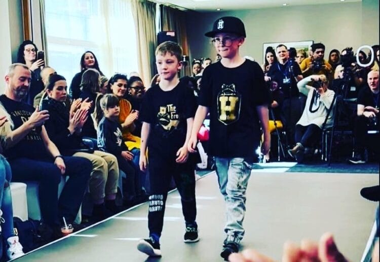 Archie (left) walks down the runway with older brother Dexter