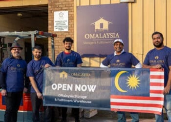 Simon Suresh with staff at the opening of the new OMayalsia warehouse in Leicester