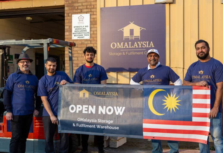 Simon Suresh with staff at the opening of the new OMayalsia warehouse in Leicester