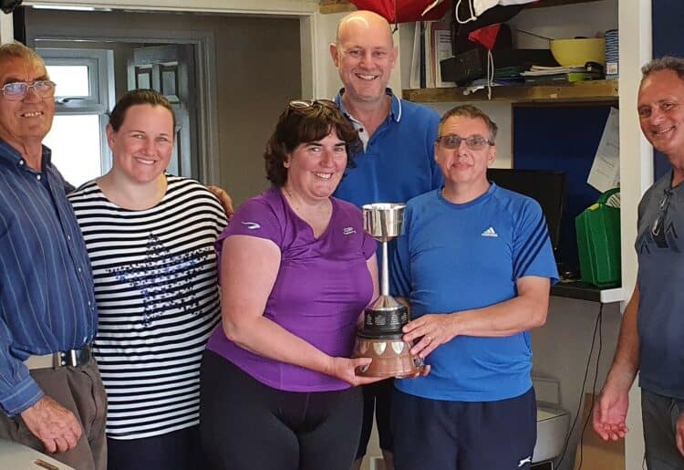 the winning team of Mel and Ian Wickens, Graham Smith, Commodore Shiri Drake, and John Beech, having received the trophy from the Vice Commodore, Roland Briggs.