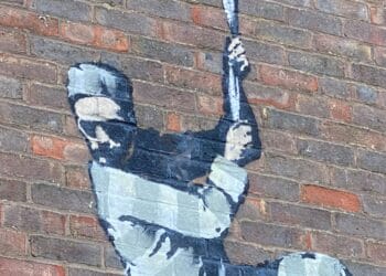 The Banksy mural on the wall of Reading Gaol, featuring an escapee shimmying down a reel of paper to a typewriter.