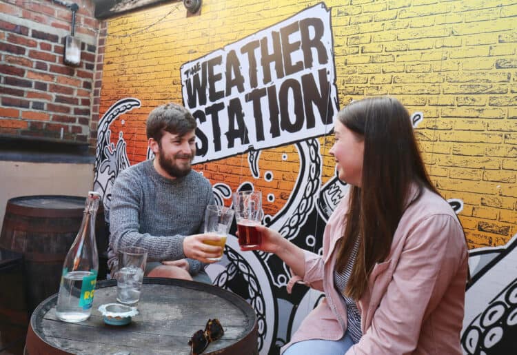 A couple enjoy a drink in The Weather Station's beer garden