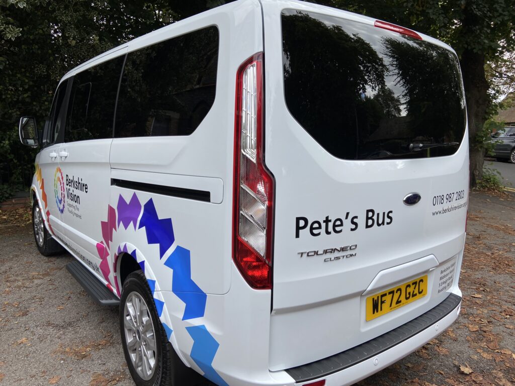 A white minibus has been decorated with colourful livery of Berkshire vision. The boot of the vehicle is printed with "Pete's Bus". Picture: Courtesy of Berkshire Vision