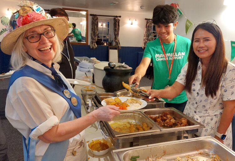 Hurst Morris People dancer Sheila Cook being served tasty Thai food by Leo Bello, 13, and Yuti Ellis. Pictures: Sue Corcoran
