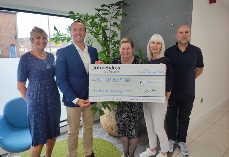 John Sykes presents a covid grant to Autism Berkshire