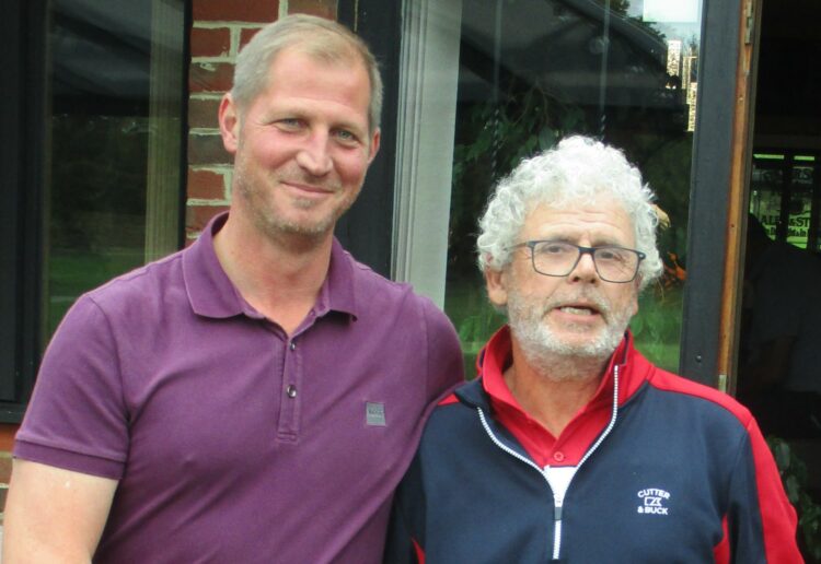 David being congratulated by the Club Captain, Lee Barrett, Davd is the one smiling.