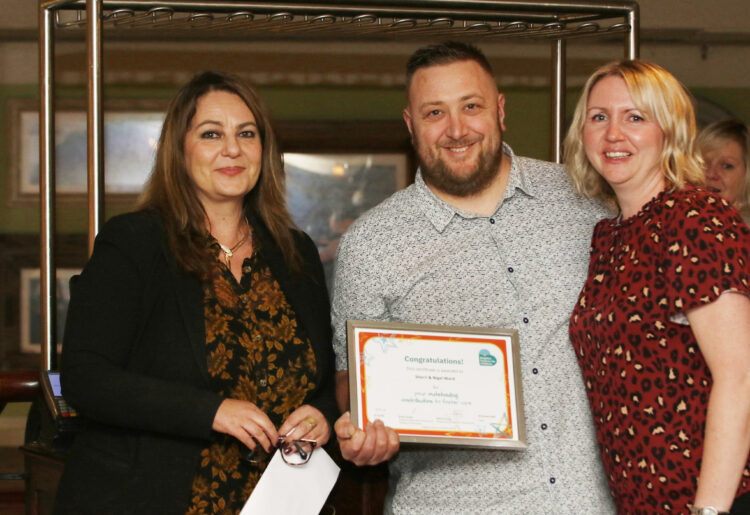 Nigel and Sherri Ward receiving the Outstanding Contribution to Fostering Award from Maria Young. Picture: Courtesy of Brighter Futures for Children