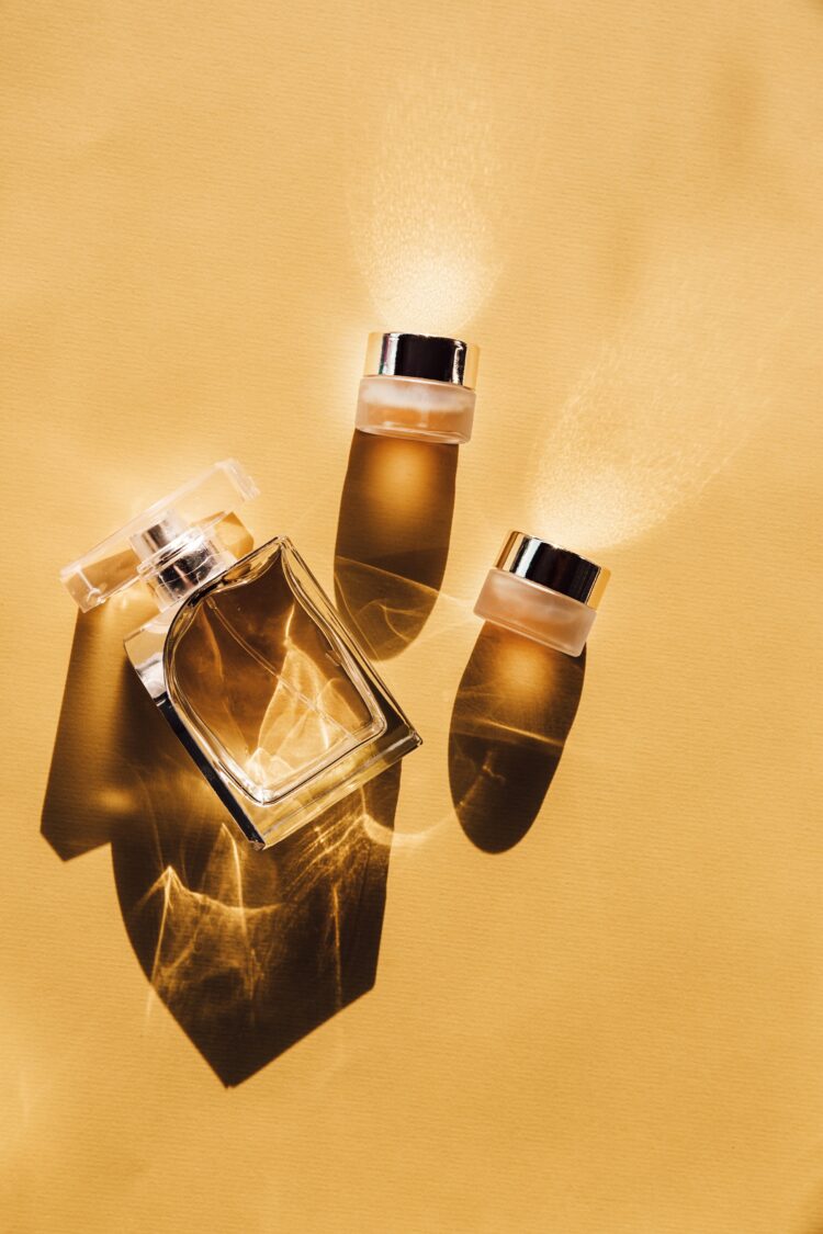 Three bottles of perfume lay on a golden yellow background. Picture:Birgith Roosipuu via US
