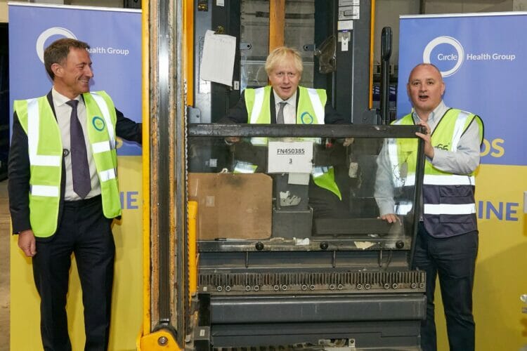 Circle CEO Paolo Pieri, left, and former prime minister Boris Johnson, centre, at the Enfield warehouse. Picture: Zoe Norfolk, courtesy of Circle Health Group