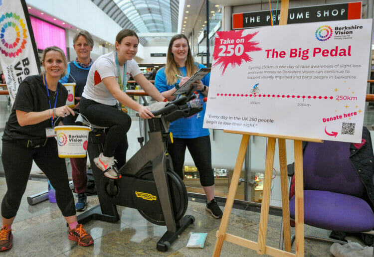 Clare Matthews, Jennie Drake, and Hannah Lennox look on as Commonwealth Games Medal Winner, Katie Crowhurst, clocks up the miles on the exercise bike. Picture: Steve Smyth
