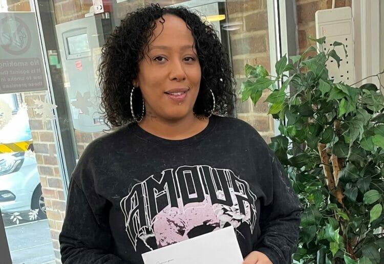 Dominique Grandison with her prize for naming Dee Space, a new community centre