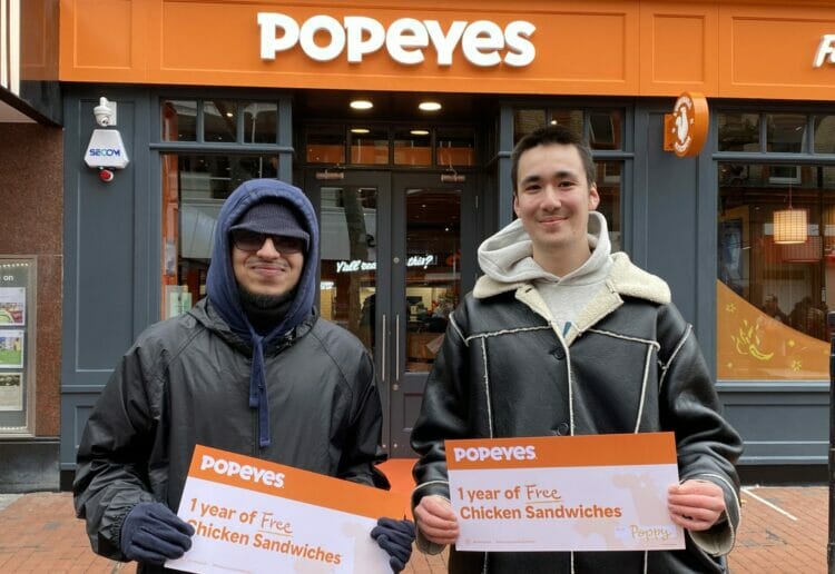 With their ?chicken cheques? are Jakaria Uddin and Damien Hall. The duo queued outside the Broad Street branch of Popeyes ahead of opening to win free chicken sandwiches for a year Picture: Phil Creighton