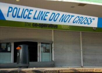 Picture shows the metal shutters of the Co-op store bent to force entry, covered by Police tape. Thames Valley Police were alerted to offenders attacking the shopfront and ATM in the early hours of Tuesday, February 14th. Picture: Jake Clothier