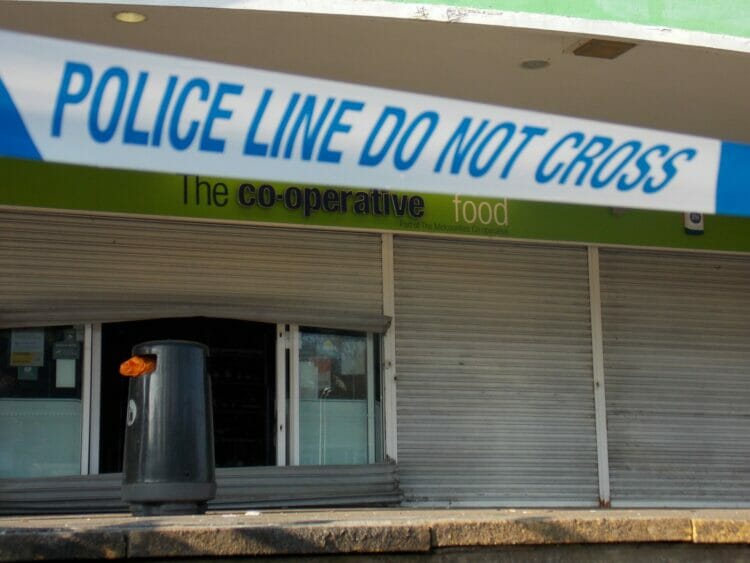 Picture shows the metal shutters of the Co-op store bent to force entry, covered by Police tape. Thames Valley Police were alerted to offenders attacking the shopfront and ATM in the early hours of Tuesday, February 14th. Picture: Jake Clothier