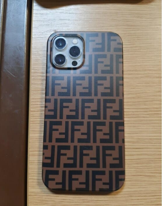 A White iPhone covered with a dark brown case, featuring 'F' and upsidown 'F' motifs. TVP is seeking to reunite the devices with their original owners. 