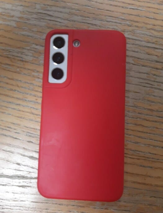 A white phone of indeterminate make, with three camera lenses in tandem, covered by a bright red case with a relief outline.TVP is seeking to reunite the devices with their original owners.