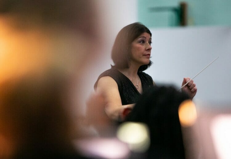Dr Charlotte Exon conducting music at Downe House School