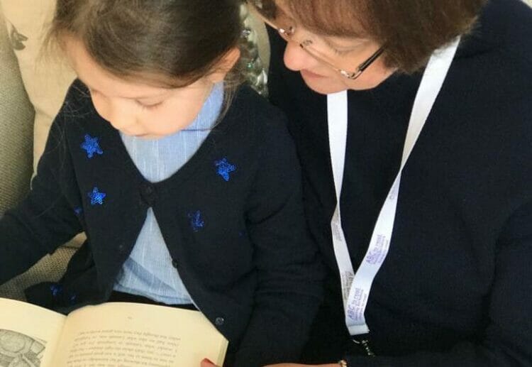 Jenny and an ABC to Read child enjoying a book. Picture courtesy of ABCtoRead