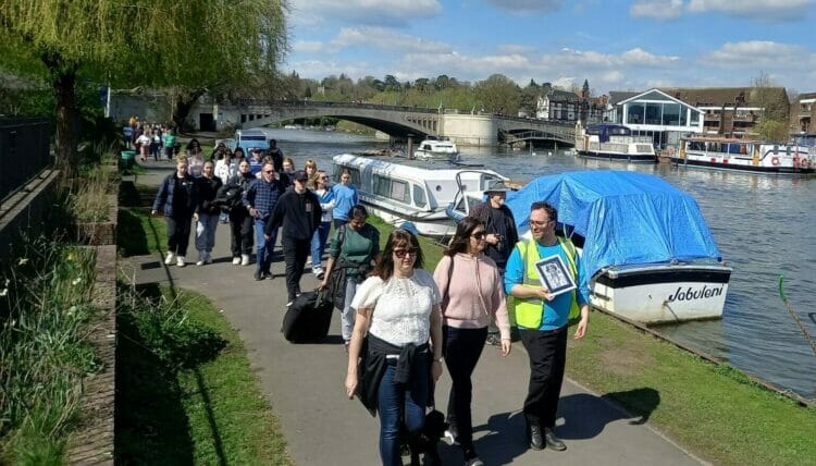 Attendees led by organisers, including James Denny, in a memorial walk in honour of Ruth Perry, following her death in January this year. Picture: Jake Clothier