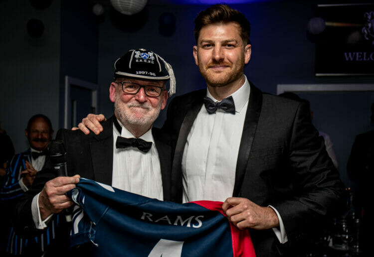 Rams' CEO Gary Reynolds presents the retiring Ollie Taylor with a shirt commemorating his 169 first-team games