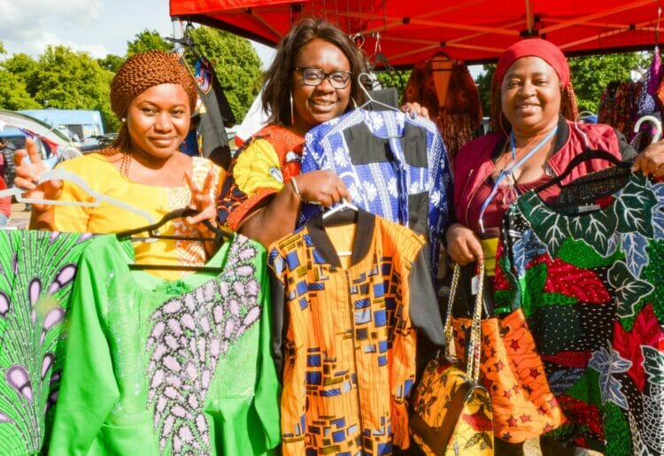 Gloria Umoh, Alaere Biakepara and Yvette Philbert with the beautiful clothes they had on their stall at East Reading Festival 2022.