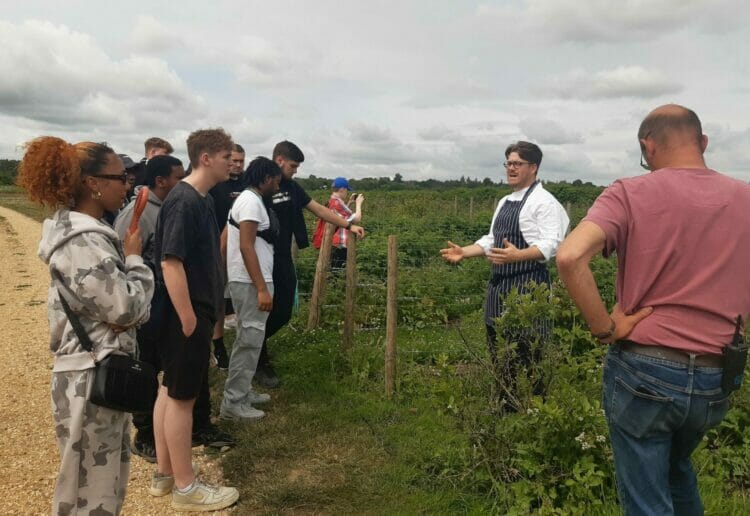 Fred Page Head Chef Marle Heckfield Place gives the students a tour of the market garden and farm