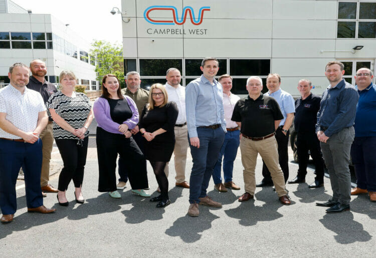 Campbell West directors Daniel West and Steven Campbell outside their Bracknell HQ with their company colleagues