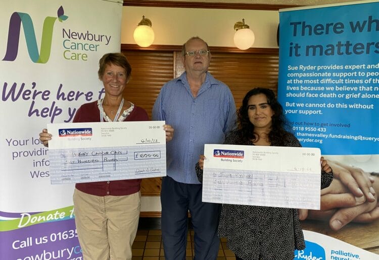 Helen MIlroy from Newbury Cancer Care and Ashni Parmar from Sue Ryder received cheques from a fundraising event organised by darts fan Peter Bush Picture: Phil Creighton