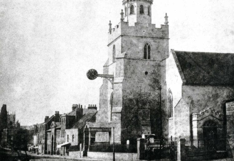 St. Giles's Church, Reading, from the south, showing buildings on the east side of Southampton Street, the church tower with the clock on a bracket and porch to the west door, and the south door. Picture: W. H. Fox Talbot. 1840-1849/Reading Borough Libraries/Wikipedia