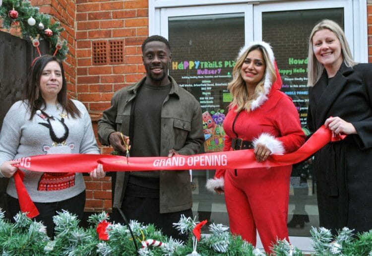 The Opening of the Happy Trails Play Nursery in Shinfield on Saturday. Andy Yiadom cuts the tape to open the new Nursery as Joty Bhurji (in Santa Outfit) look on.