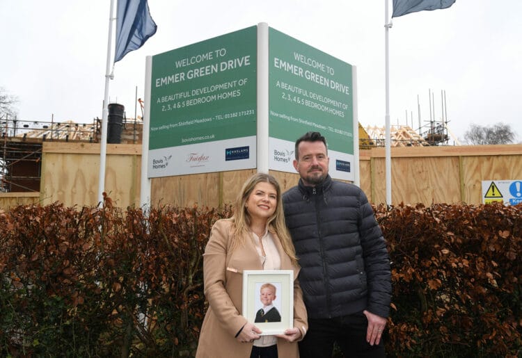 Louise and Mathew Fox with a photo of their son George, at Vistry Group?s Emmer Green Drive location in Reading where a street is to be named after him
