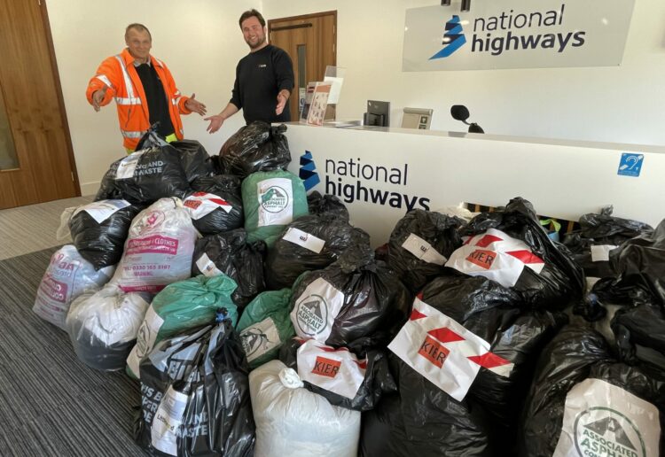 John Beale (left) and Charlie Parkhouse from Kier with some of the donations National Highways collected for air ambulances