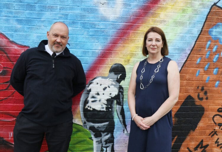 Stuart and Amanda Stephens in front of part of the mural; Amanda Stephens unveils mural for son Olly  by Peachy at Emmer Green Primary School Picture: Dijana Capan/DVision Images