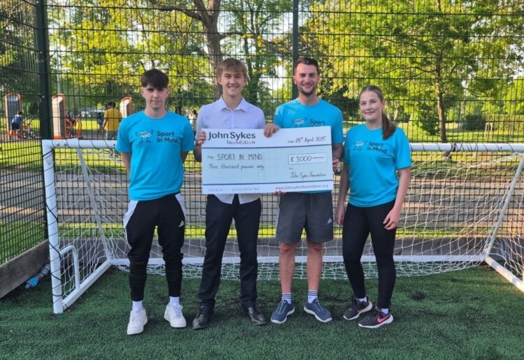 The John Sykes Foundation presents a cheque to Sport in Mind
