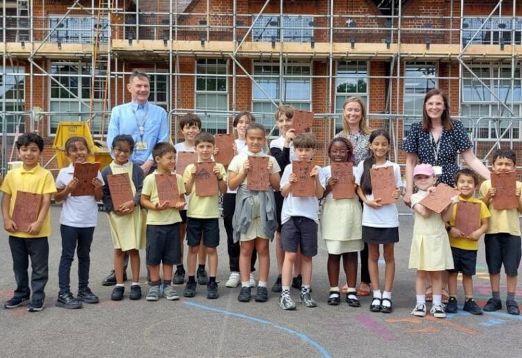 Children from Alfred Sutton Primary School took part in the project to replace the school roof by making their mark on some of the tiles to be used. Picture: Reading Borough Council