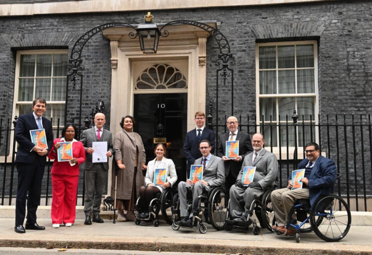Dani Czernuszka-Watts from Reading pictured centre with MP's and representatives from the Spinal Injuries Association.